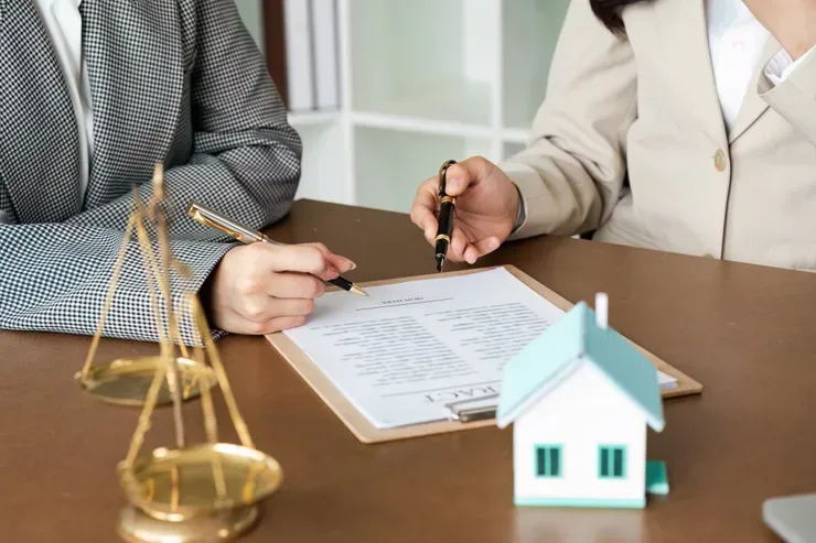 Two people reviewing a legal document together.